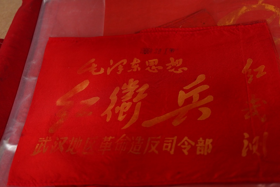 A Chinese Cultural Revolution flag, three armbands, a red book, a badge and a small flag-85cm wide x 102cm long